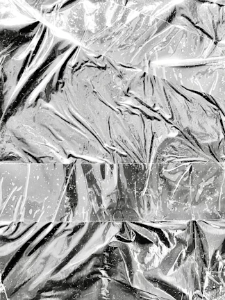Aluminum sheets reflecting light, highlighting their smooth, clean surfaces.