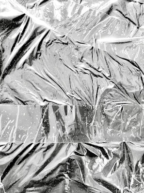 Abstract metallic textures reflecting light, hinting at the strength of aluminum.