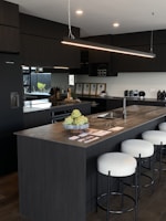 a kitchen with a center island with stools