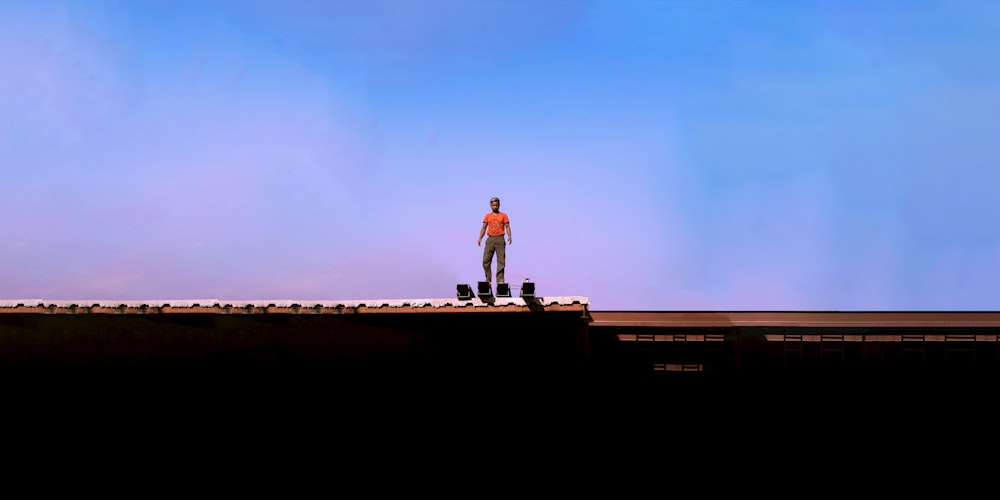 a man standing on top of a roof