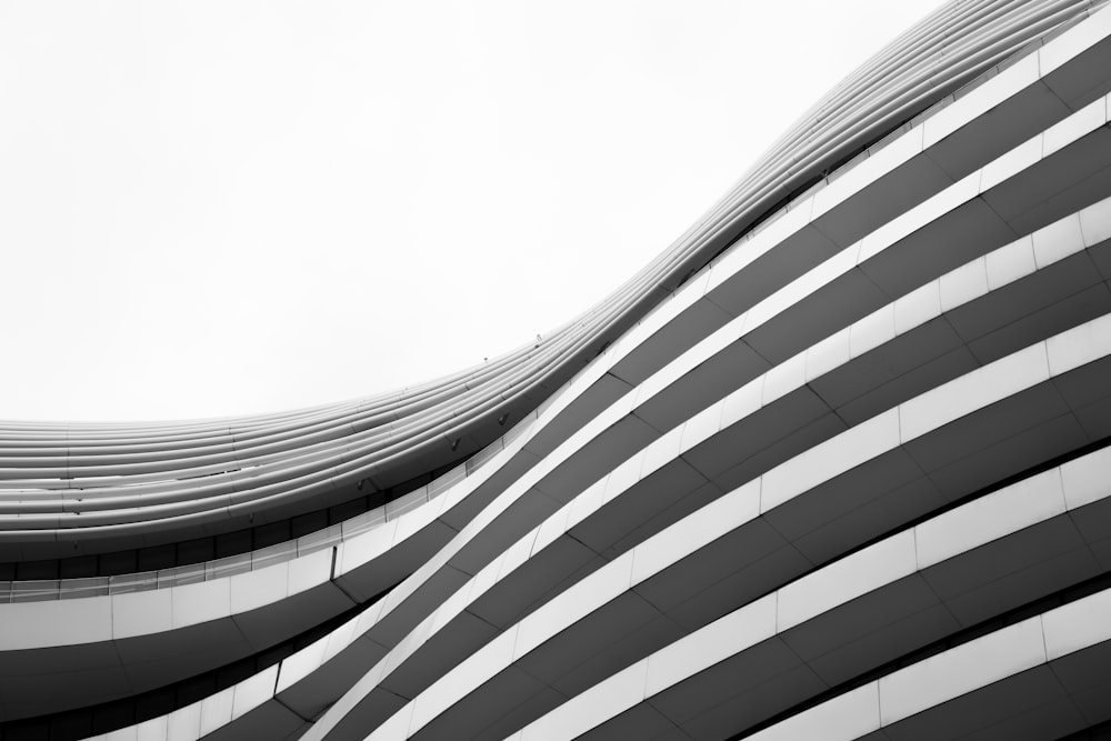 a black and white photo of a curved building