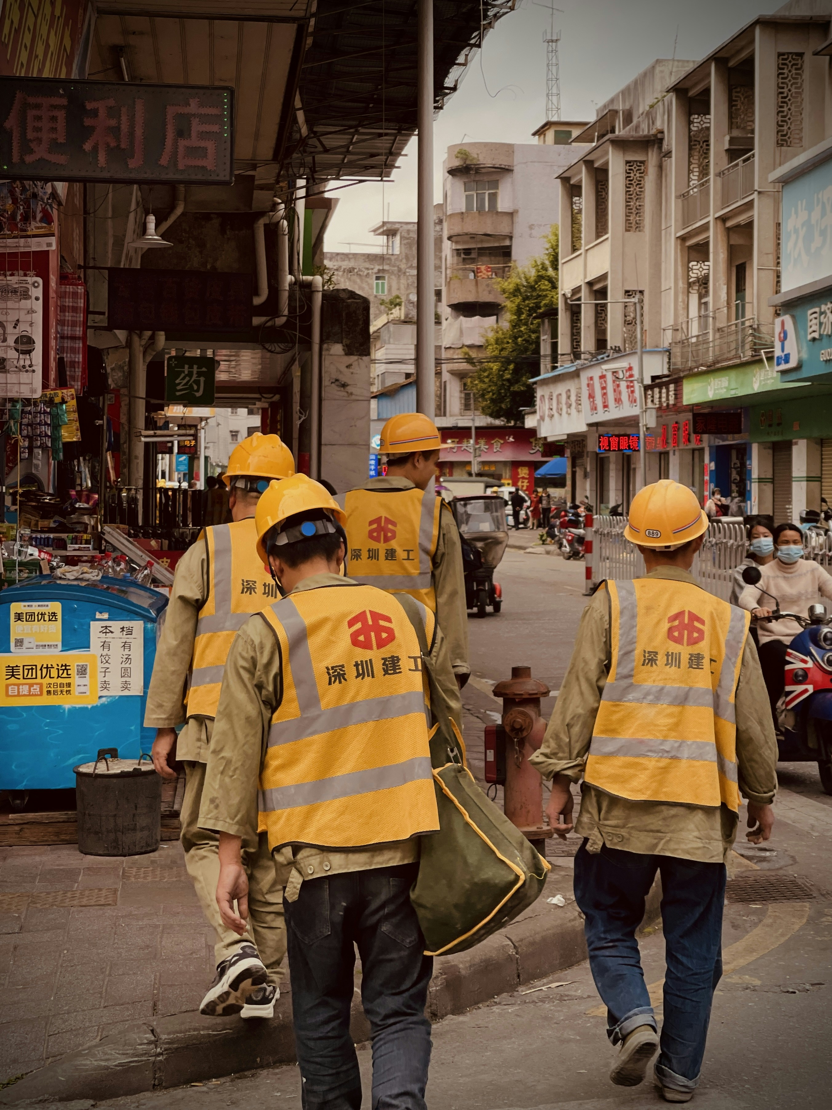 a group of men walking down a street