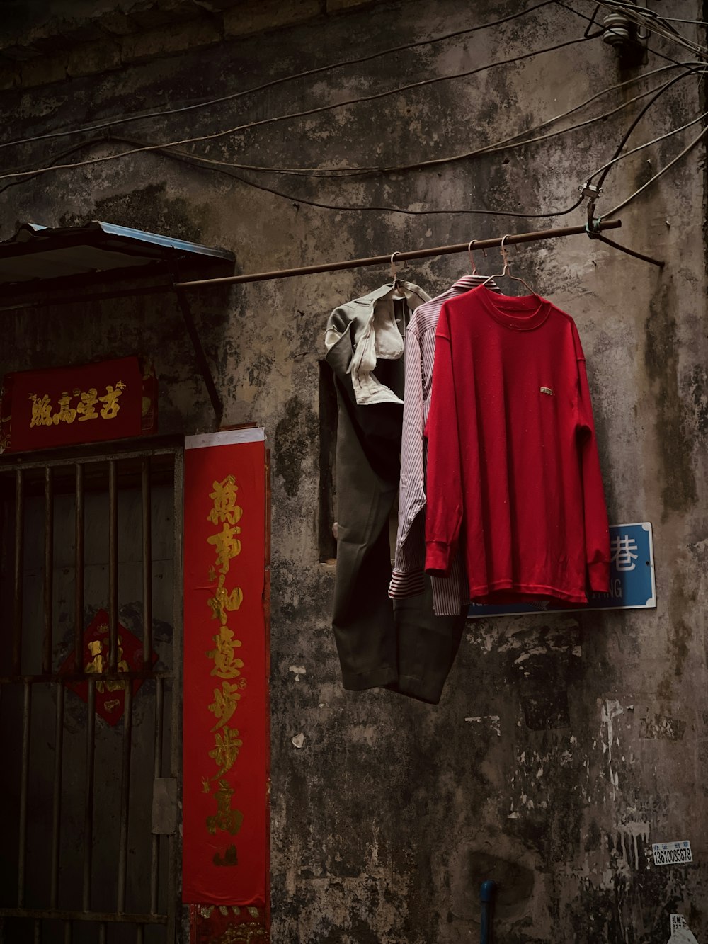 a red shirt hanging on a clothes line