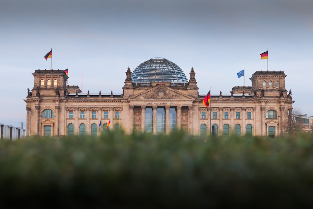 a large building with flags on top of it