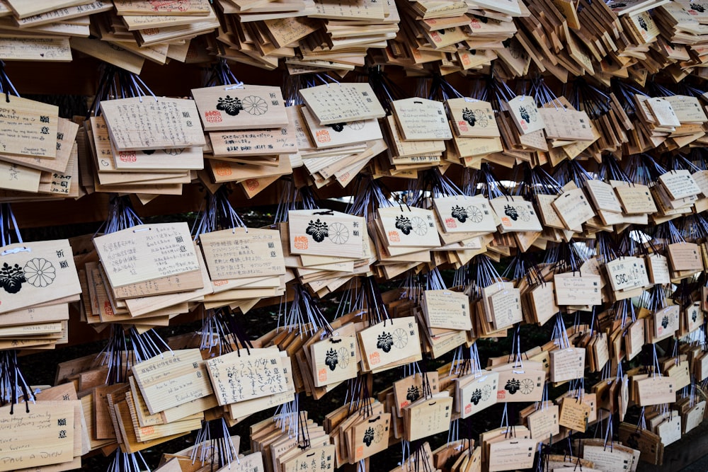 a wall covered in lots of wooden tags