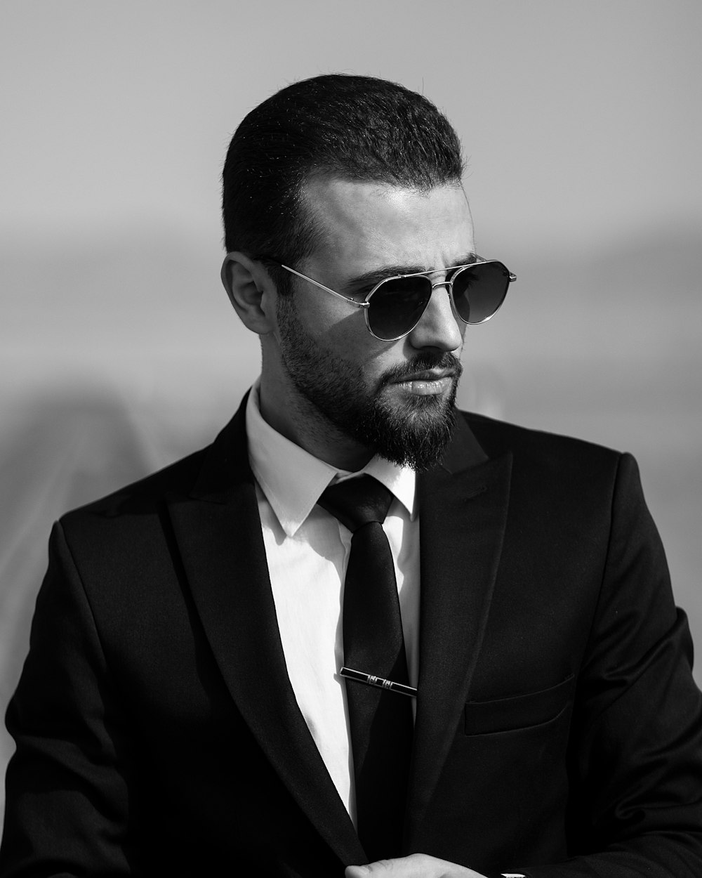 a man in a suit and tie wearing sunglasses