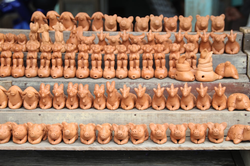 a display of clay heads on a shelf