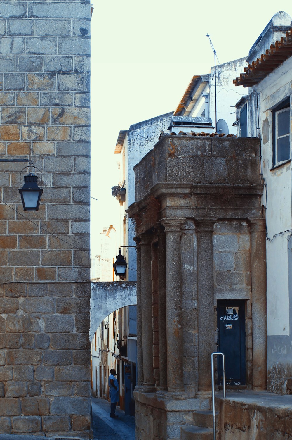 a street with a brick building and a clock tower