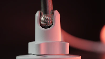 Detailed shot of a 3D-printed accessory showcasing fine industrial design lines under soft, cold electric white lighting.