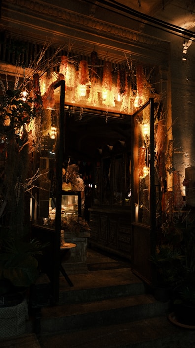 A cozy floral shop interior with wooden shelves and soft lighting.