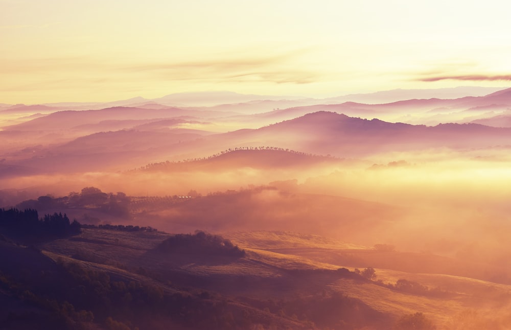 a view of a mountain range covered in fog