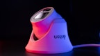 A sleek, modern security camera with a white base and lens casing, highlighted by red and purple lighting, set against a dark background. The camera brand name is visible on the side.