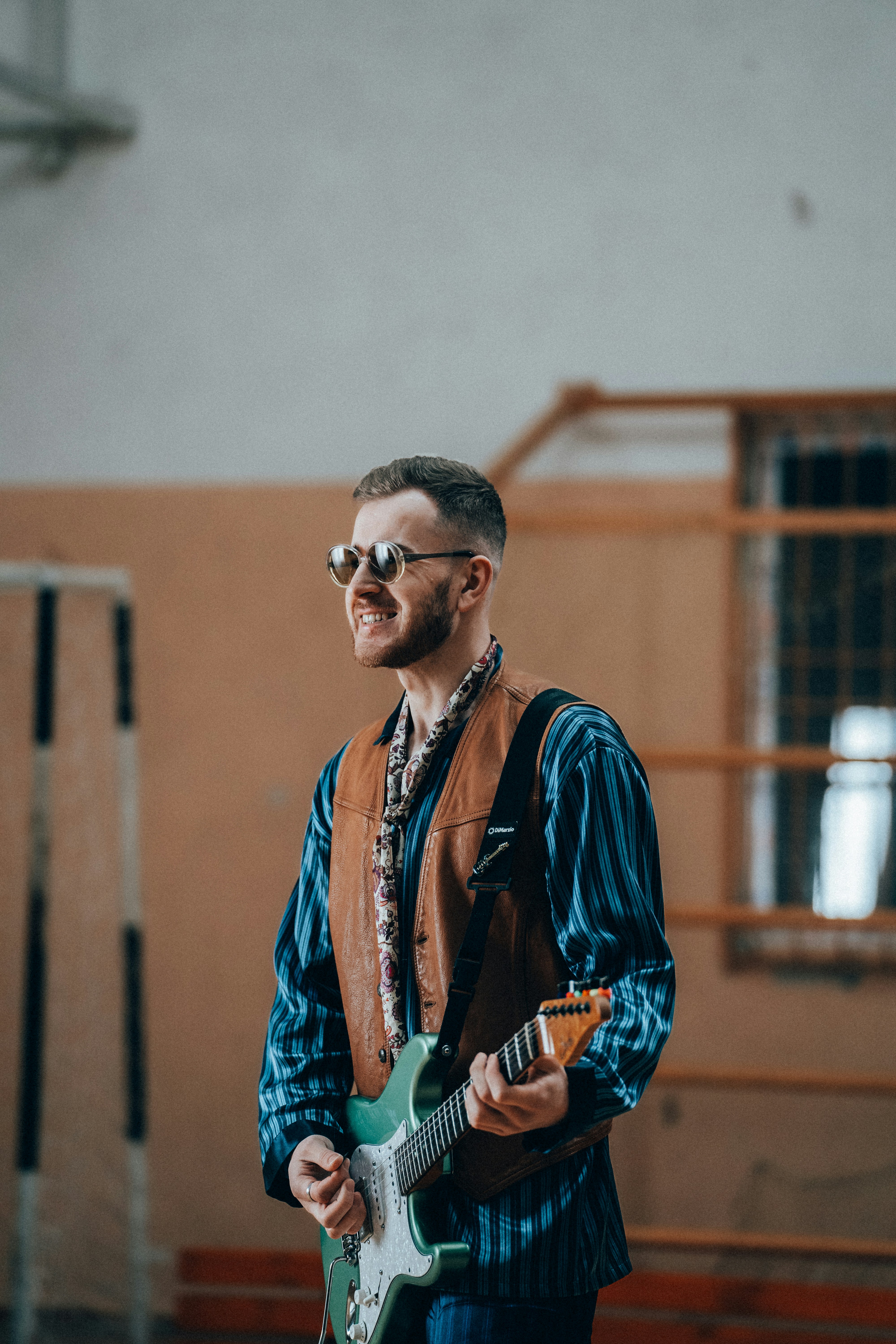 a man standing in a room with a guitar