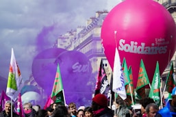 a crowd of people standing around a large balloon
