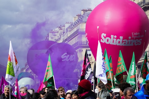 a crowd of people standing around a large balloon