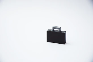 A sleek beige suitcase standing elegantly against a clean white backdrop, embodying minimalist luxury.