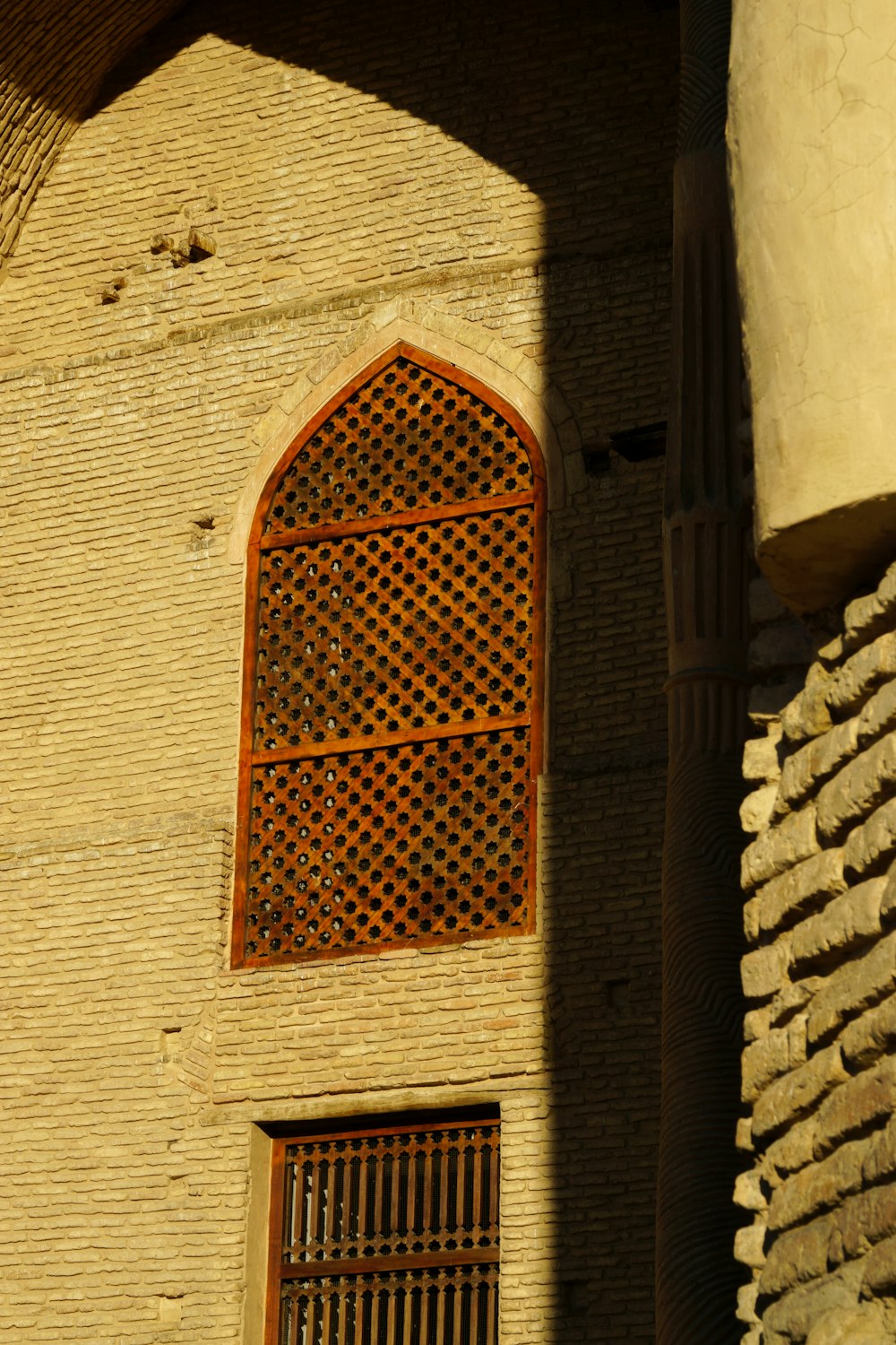 a stone building with a window and bars on the side