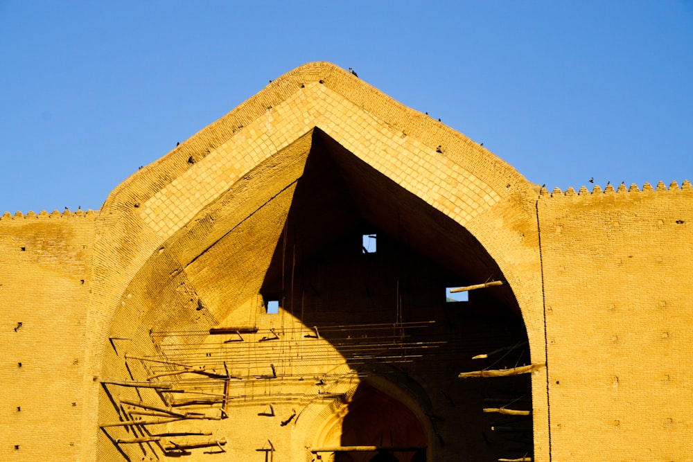 a yellow building with stairs leading up to it