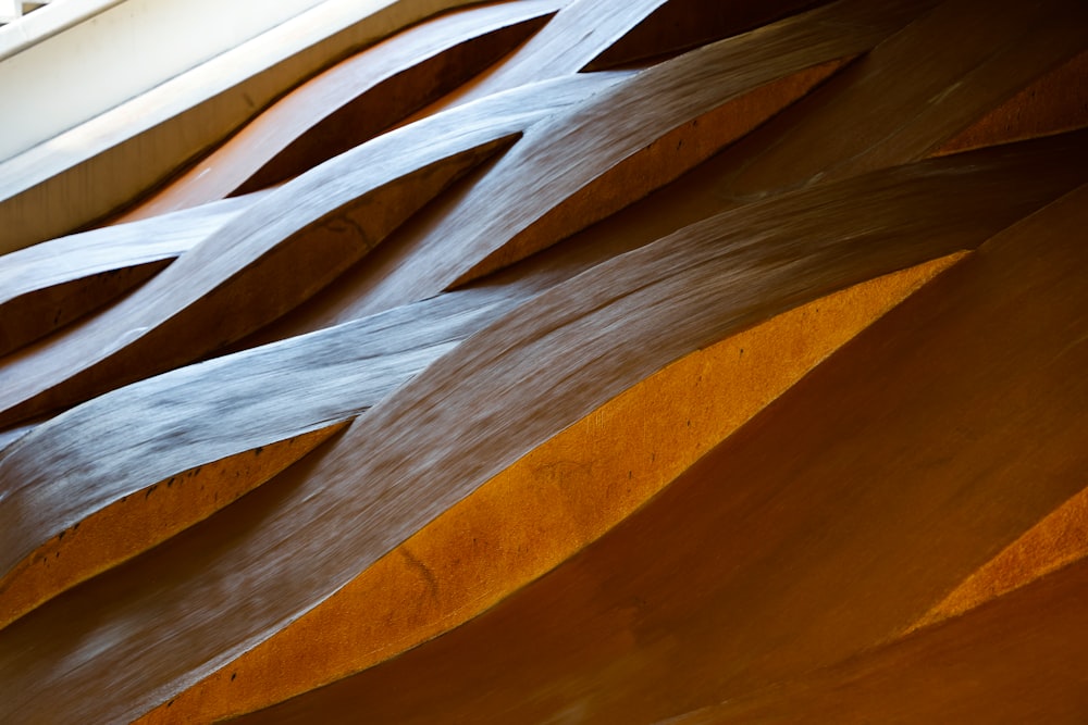 a close up of a wooden structure with a window in the background