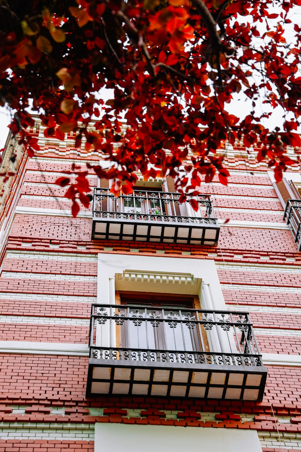 a tall red brick building with balconies and balconies