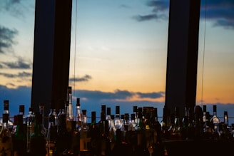 A vibrant bottle of traditional Chinese baijiu with a backdrop of the San Francisco Bay Bridge at sunset.