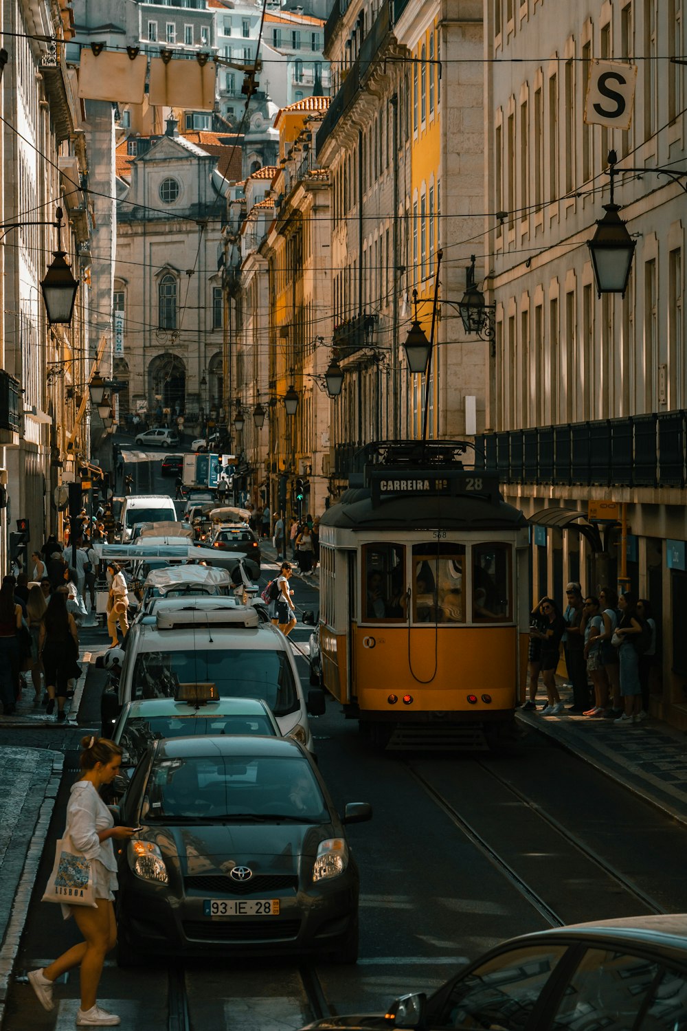 a city street filled with lots of traffic next to tall buildings