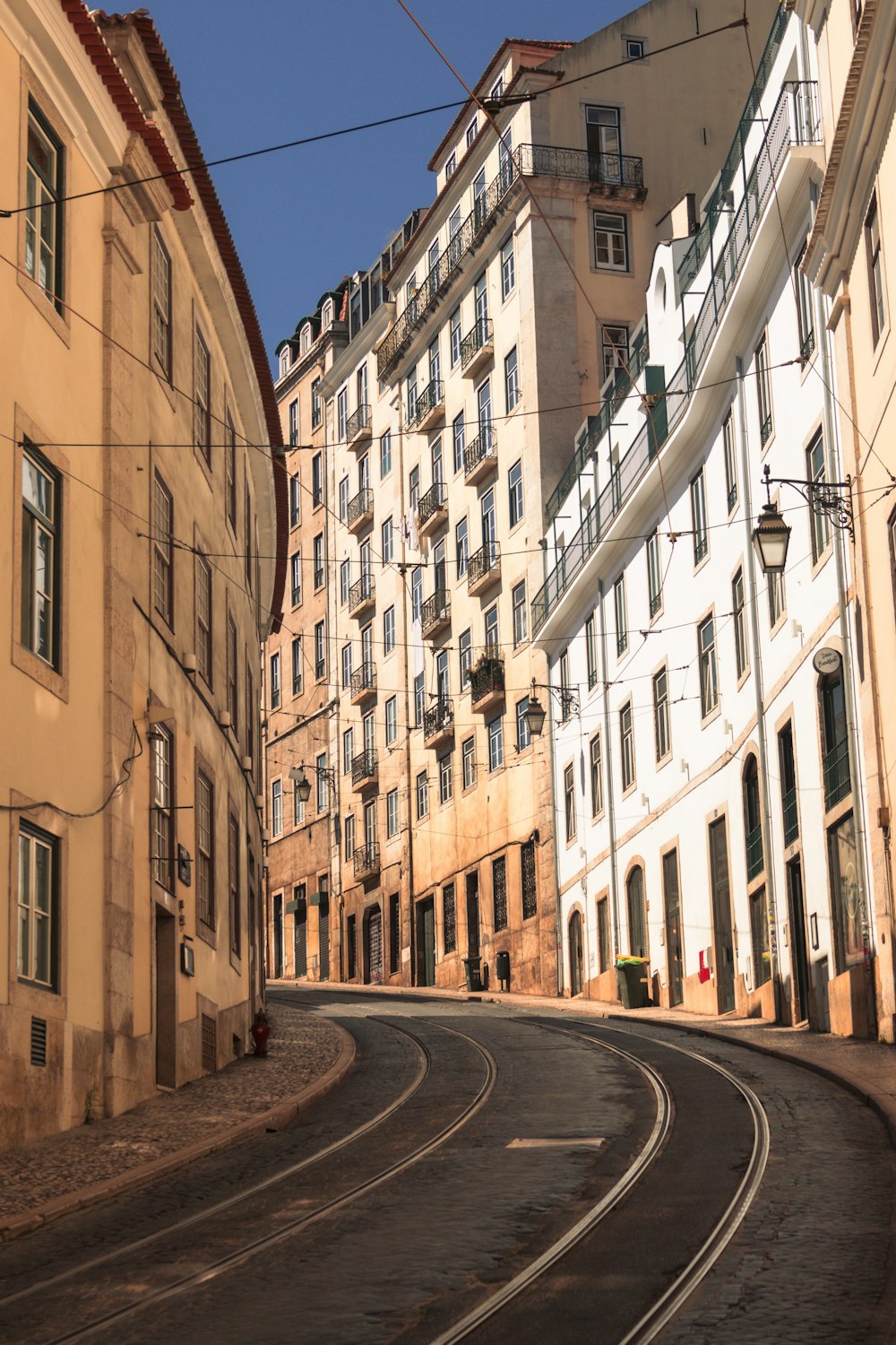 a curved road in a city with buildings in the background