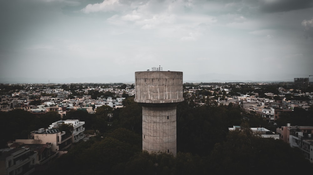 a tall tower sitting above a city under a cloudy sky