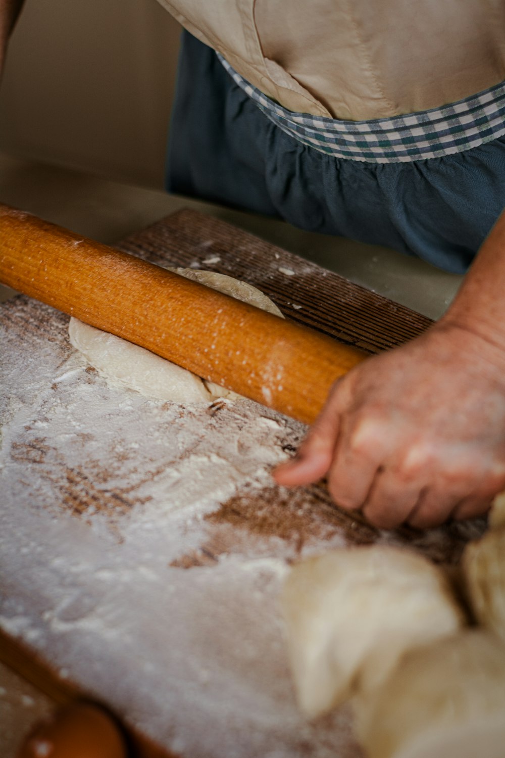 a person kneading dough on top of a table