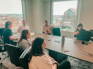 Casual meeting over coffee with team discussing health tech innovations.