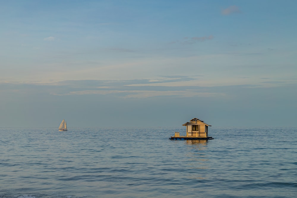 a small house in the middle of the ocean