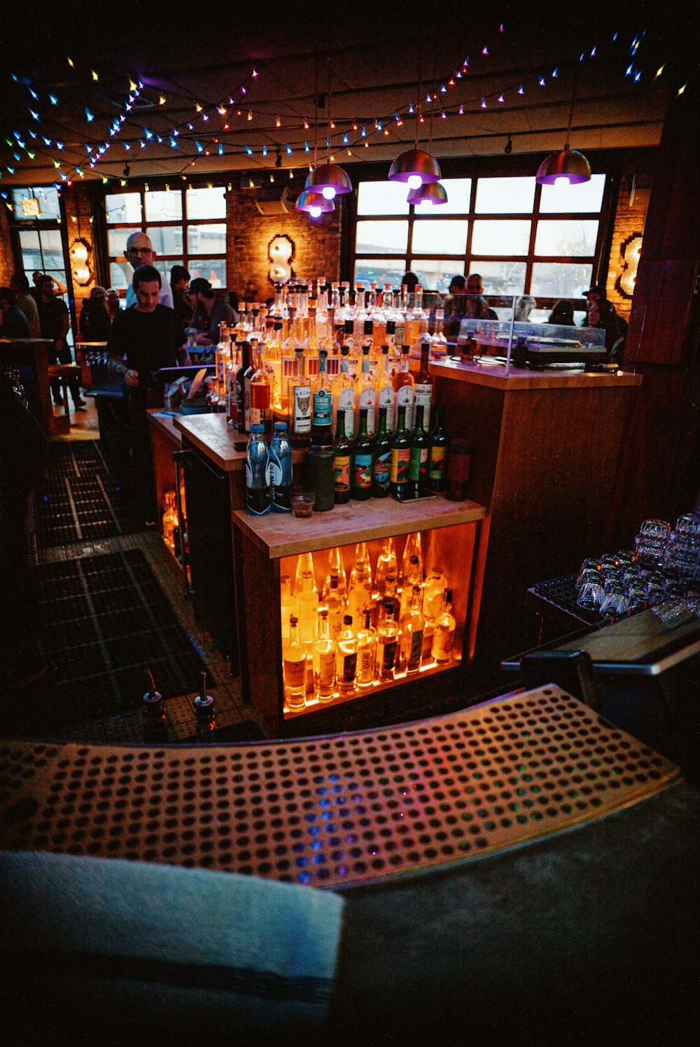 a bar filled with lots of bottles of alcohol