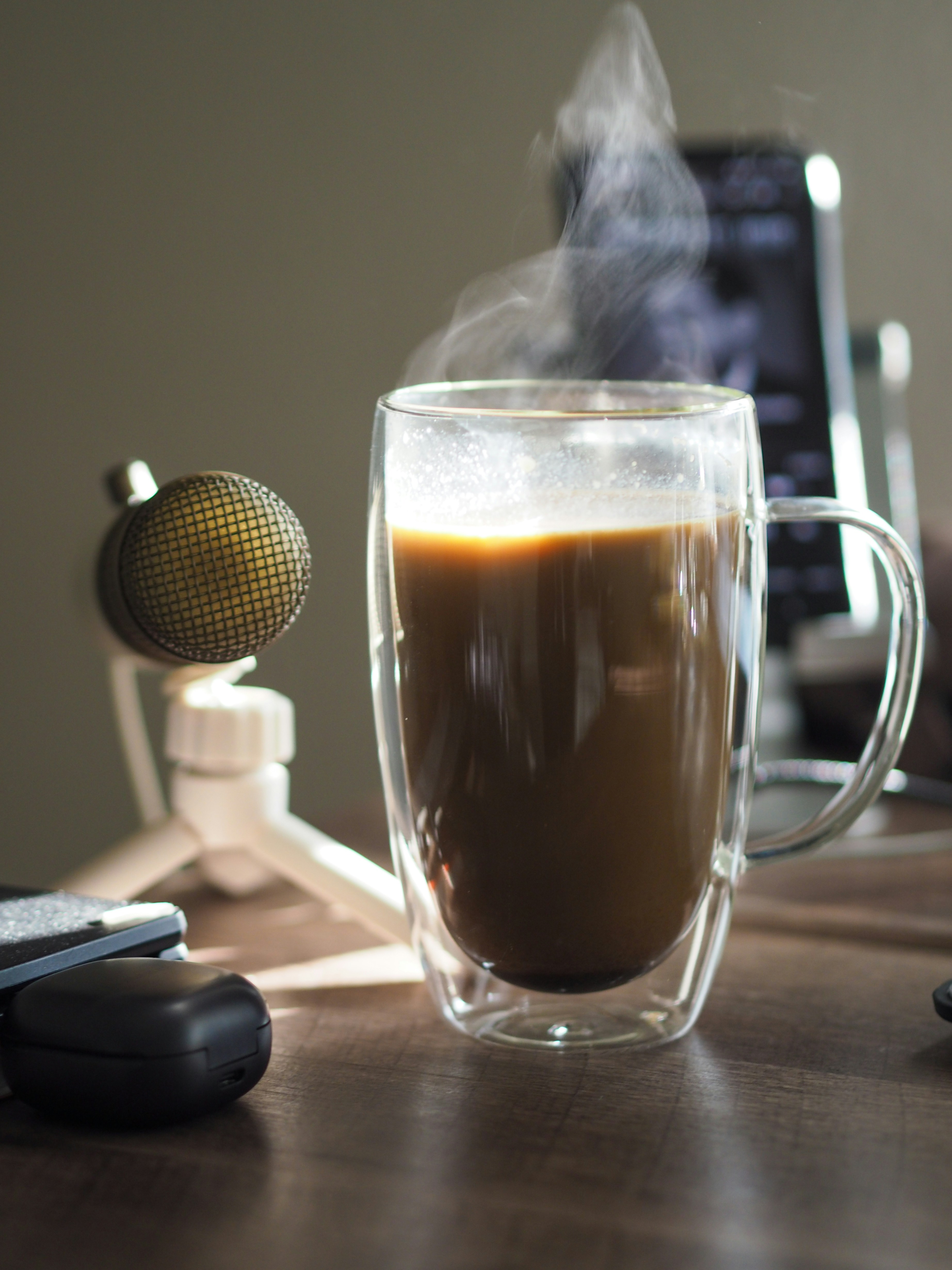 a cup of coffee sitting on top of a wooden table