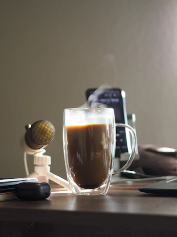 A warm office desk with a laptop, notebook, and a cup of coffee inviting connection.