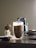 A cozy home office setup with a laptop and a cup of coffee, symbolizing connectivity and productivity.