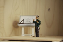 a figurine of a man taking a picture of a desk