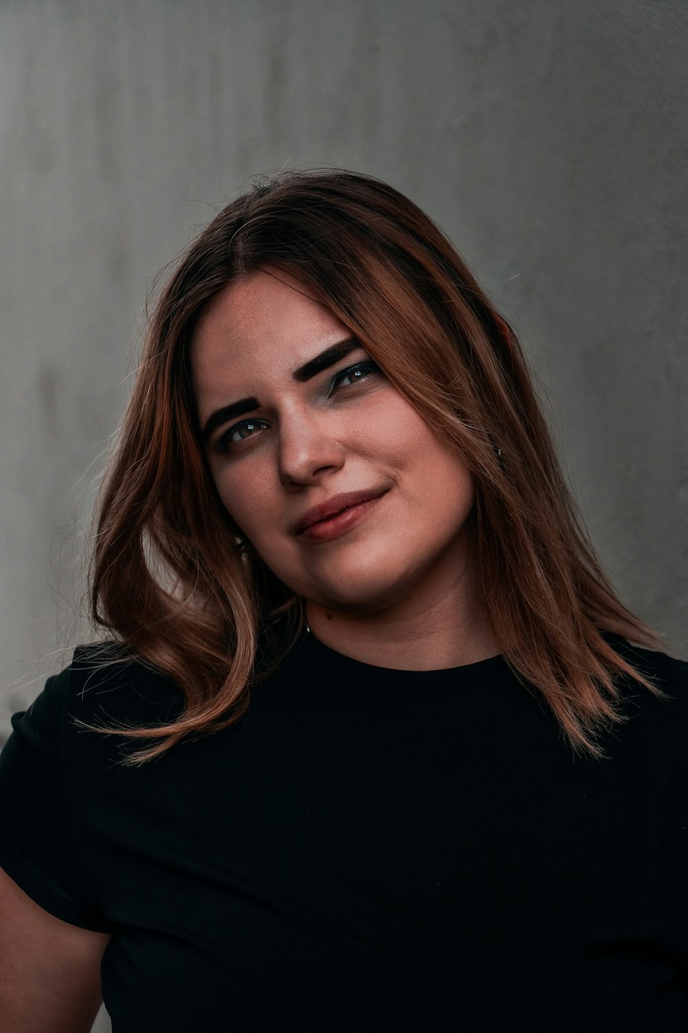 a woman wearing a black shirt posing for a picture