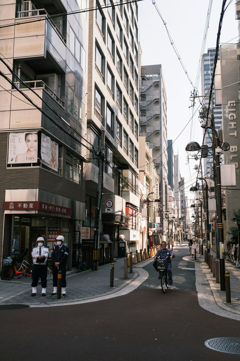 a group of people riding bikes down a street