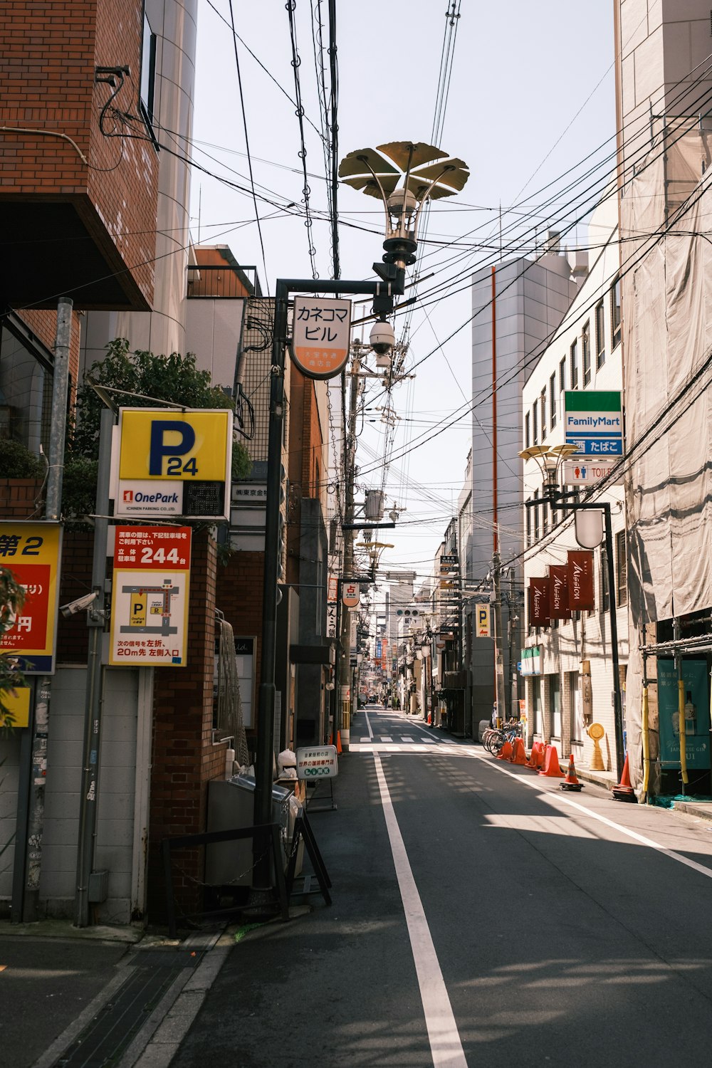 a city street with lots of power lines above it