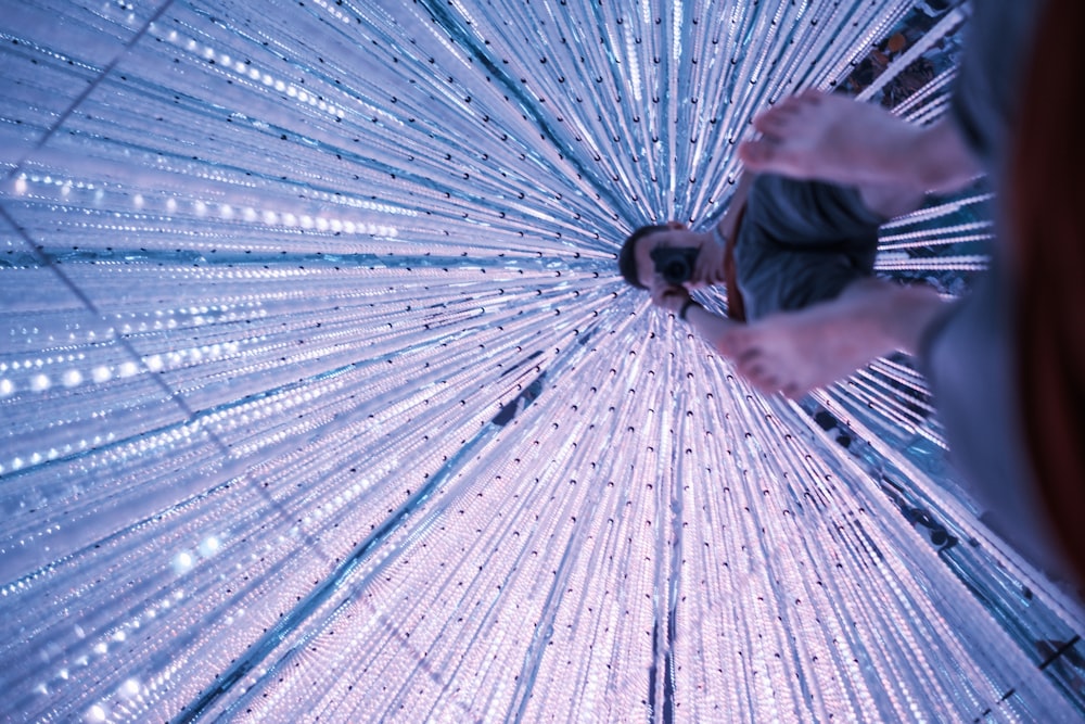 a person standing in front of a large umbrella