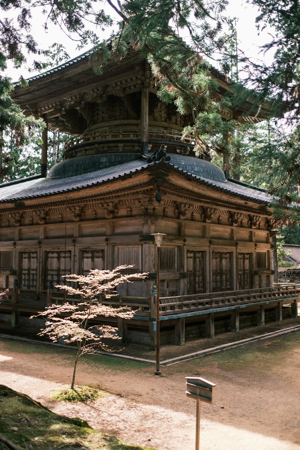 a wooden building with a tall tower in the middle of a forest