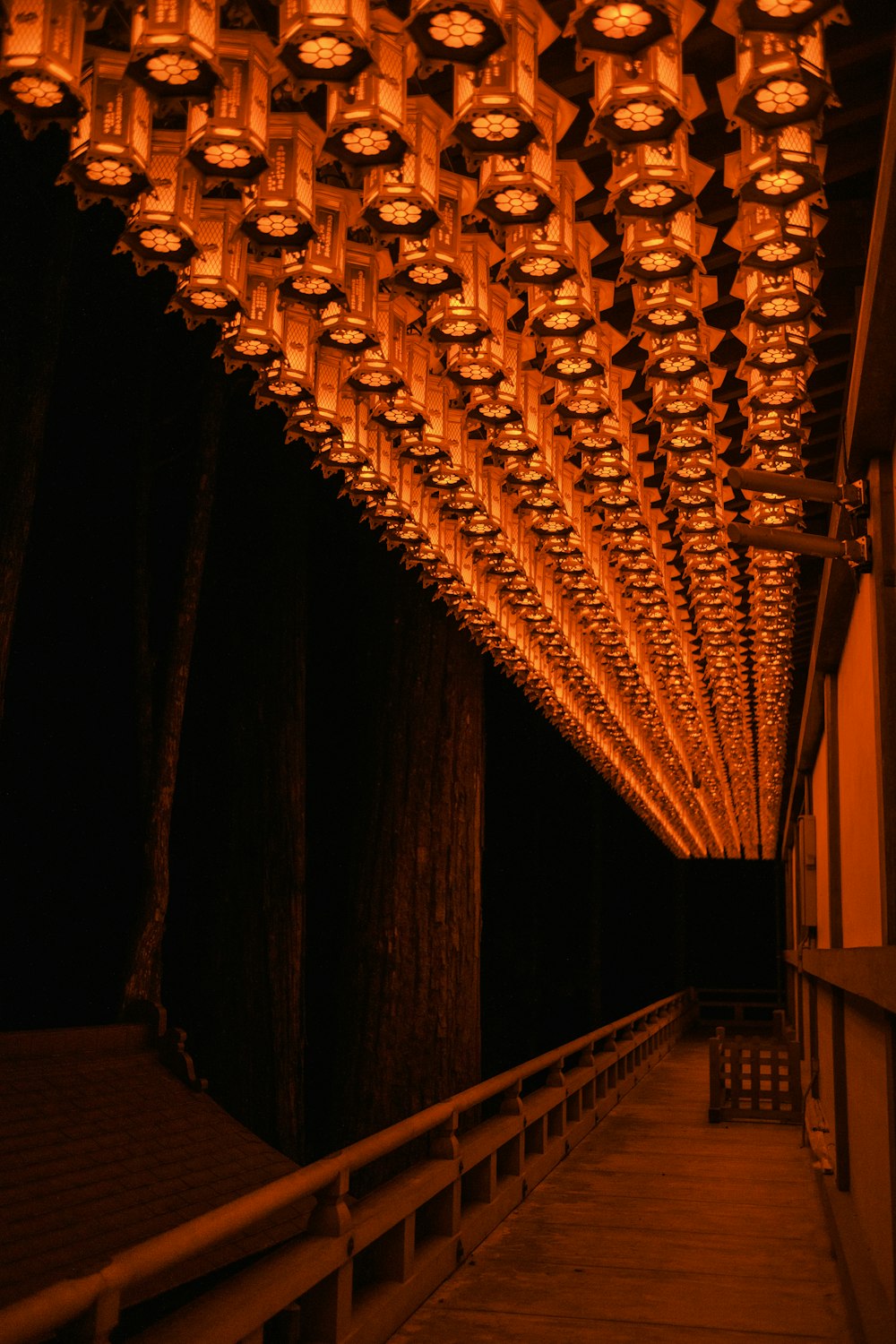 a walkway with lights hanging from the ceiling