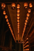A peaceful corner with softly glowing lanterns and ancient scrolls hanging on the wall.