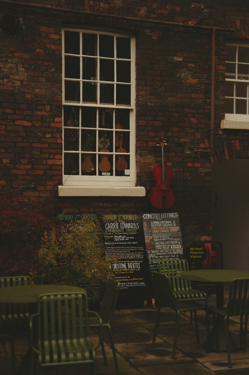 a brick building with tables and chairs in front of it