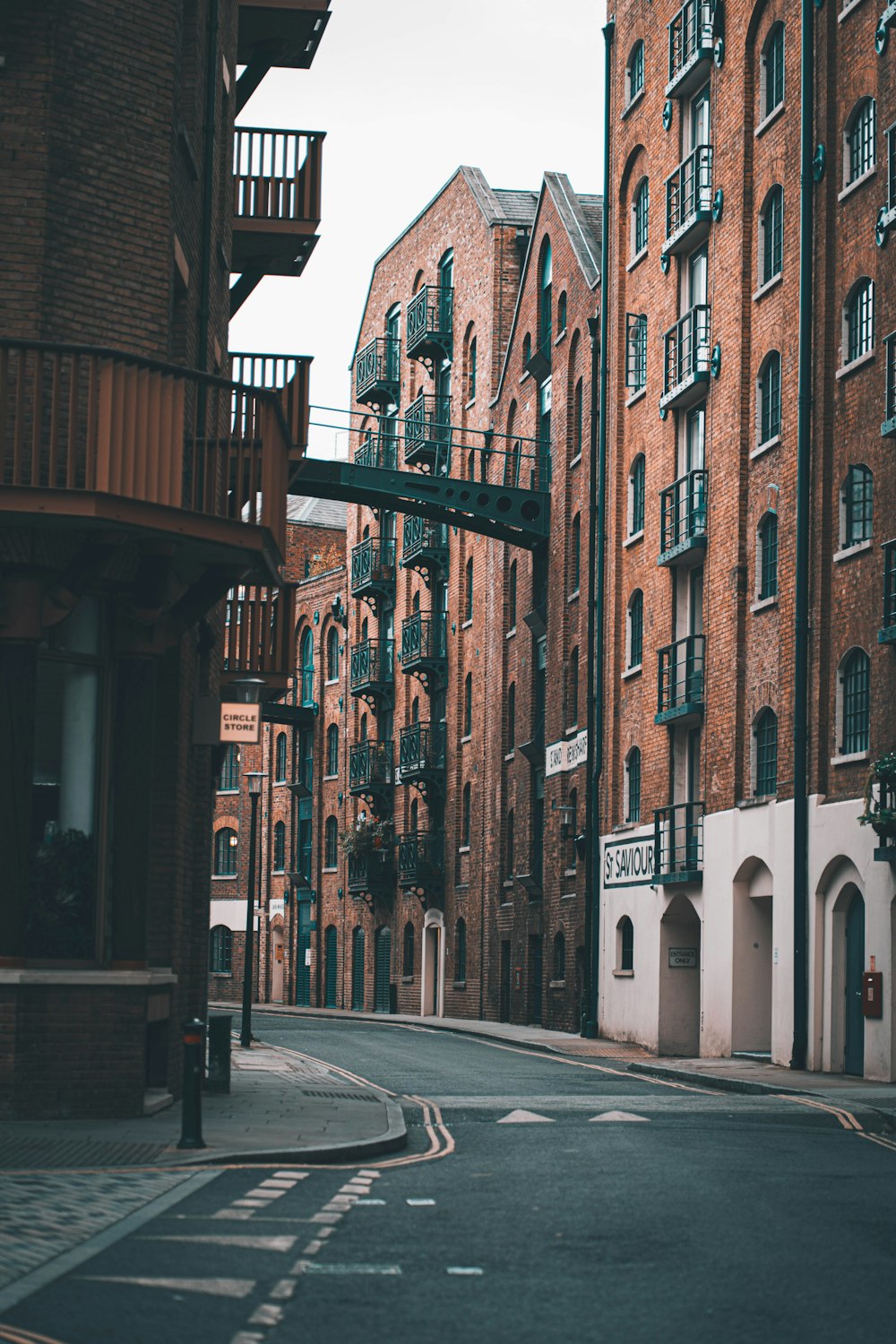 a city street with tall brick buildings on both sides