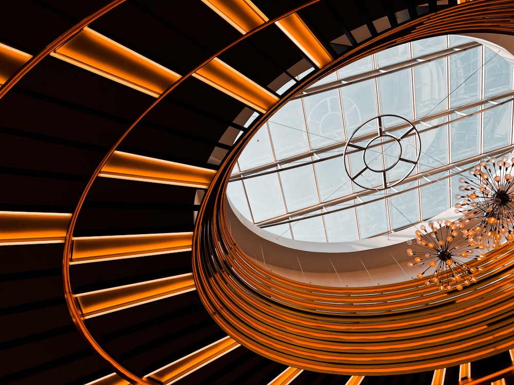 a circular light fixture in a building with a skylight
