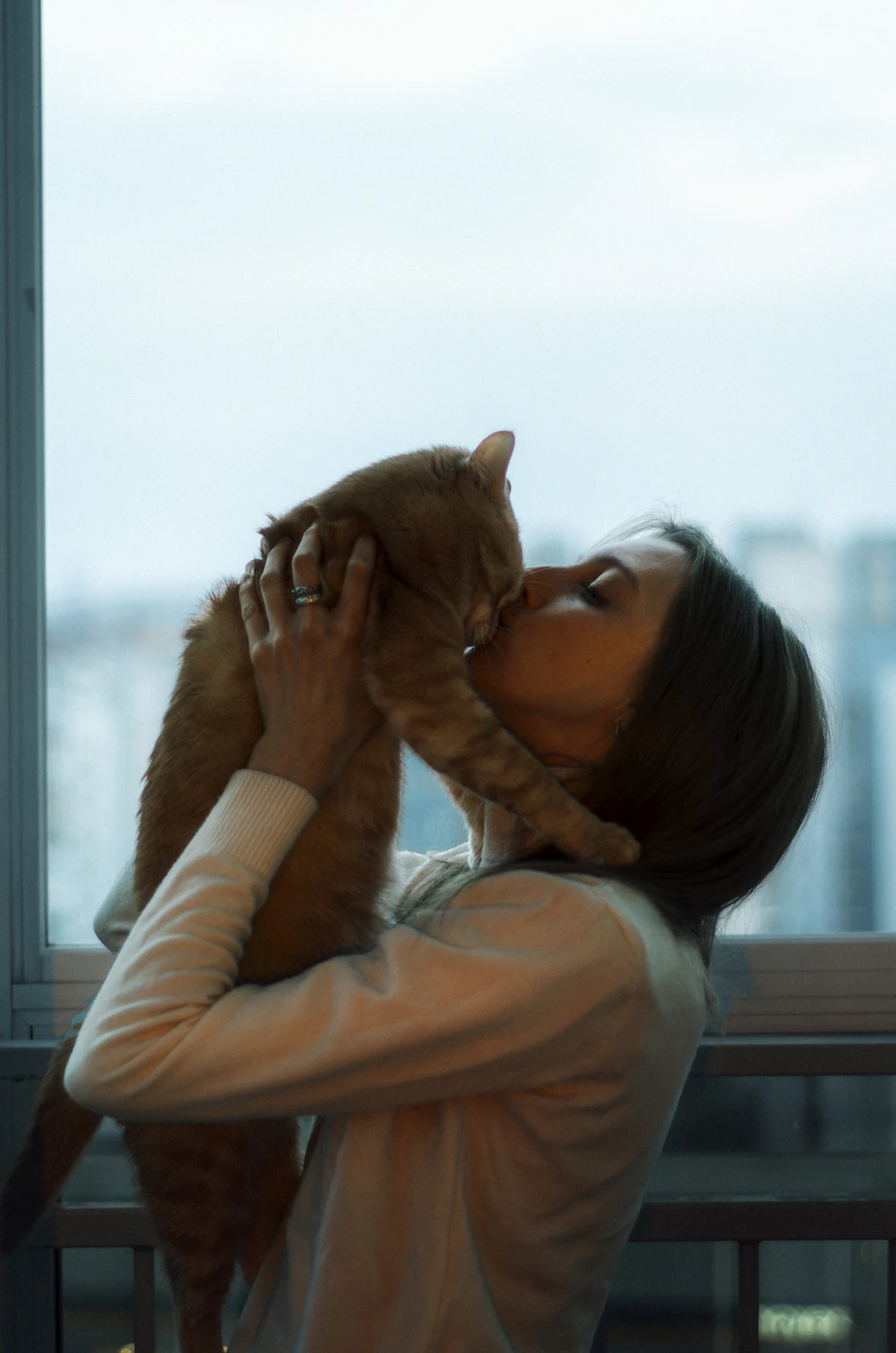 Resident holding her cat close to her face