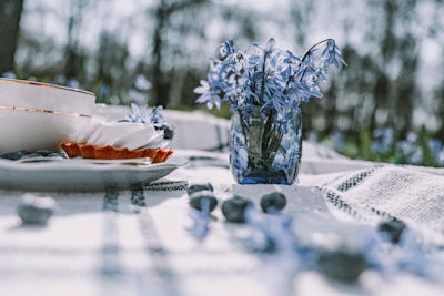 A serene travel setting featuring a picnic with colorful plant-based dishes overlooking a lush landscape.