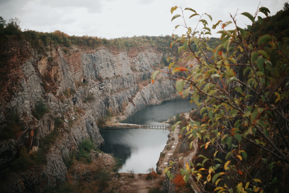 a large body of water surrounded by a rocky cliff