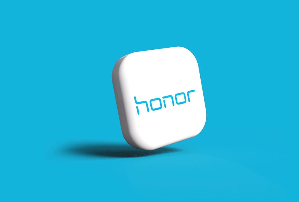 a white button with the word honor on it